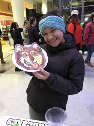 Dog portrait pancake art being held by owner.