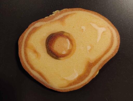 Pancake art of a fried egg.
