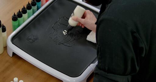 Bulbasaur pancake art step 2.1: Fill in bulbasaur's pupils and eye edges with white, leaving the irises empty.