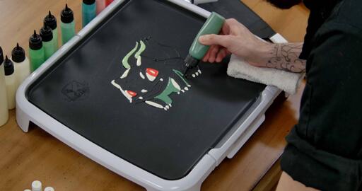 Bulbasaur pancake art step 4.1: Begin filling in the dark blue green shadows under bulbasaur's head and arms.