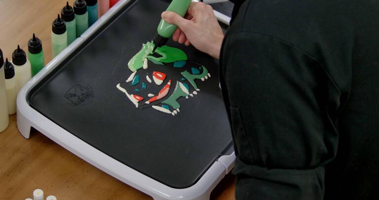 Bulbasaur pancake art step 6.1: Begin filling in the rest of bulbasaur's bulb with your middle green batter.