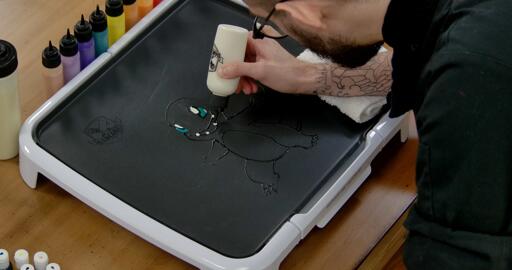 Charmander Pancake Art step 3.1: Using your white batter, color in charmanders teeth!