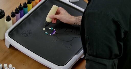 Charmander Pancake Art step 4.1: With your plain batter, begin to add highlights in certain places on Charmander's body t indicate the 'light' hitting the character.