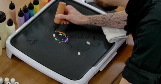 Charmander Pancake Art step 5.1: Using your darker orange batter, draw shapes to establish the areas of shading on Charmander.