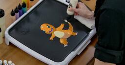 Charmander Pancake Art step 7.2: Using the white batter you have in hand, go ahead and fill in a bright core for Charmander's tail flame.