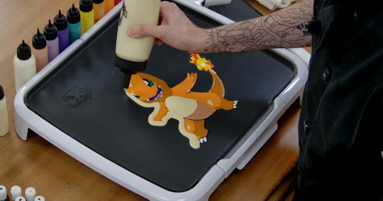 Charmander Pancake Art step 8.1: Begin outlining your pancake with plain batter - this will give it more body and hold some of the flimsy pieces (like Charmander's tail) together when it's time to flip.