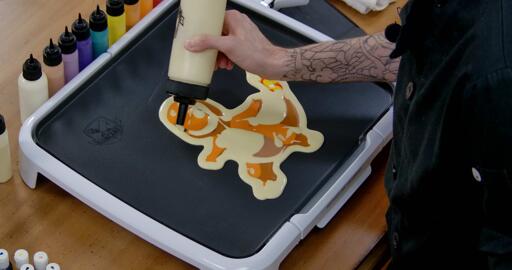 Charmander Pancake Art step 8.3: At the end I like to go back over the rest of the pancake and add a little bit of extra batter to any places where I might've missed a spot; that way there aren't any holes on the front.