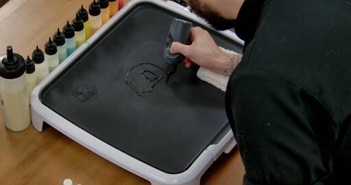 Squirtle Pancake Art step 1.1: Using your black batter, begin by drawing Squirtle's facial features and outlining the head.