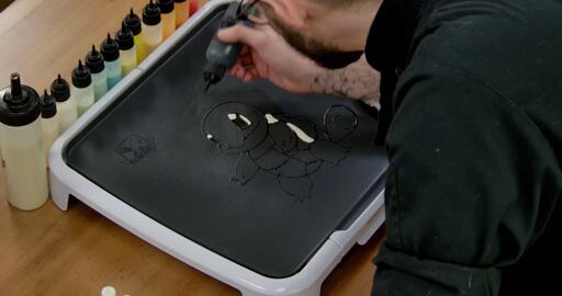 Squirtle Pancake Art step 2.2: Using black batter, add Squirtle's pupils - a black shape in the middle of each eye.