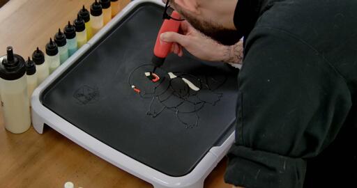 Squirtle Pancake Art step 2.3: Now, using your red batter, color in the rest of Squirtle's irises. The eyes are all done!