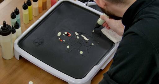 Squirtle Pancake Art step 3.1: Using your lightest blue batter, add some highlights to squirtles head, arms, legs and tail, like so.