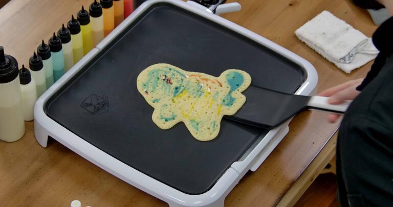 Squirtle Pancake Art step 8.1: When the pancake is loose, it's time to flip! With confidence, gently slide your spatula beneath the design...