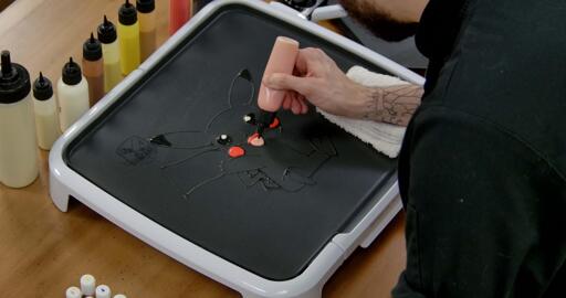 Pikachu Pancake Art step 3.3: Now, switch to your pink batter and color in the rest of Pikachu's tongue. All the facial features should be colored in now! Time to move on to highlights.