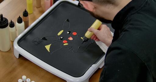 Pikachu Pancake Art step 4.2: ...a triangle on the top of the tail, and some other smaller ovals on the arms and knees...