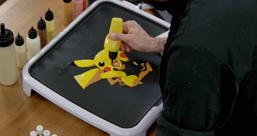 Pikachu Pancake Art step 6.2: Pikachu uses a lot of yellow! If you start to run out of batter, you can always refill your batter pens as you go. Take your time!