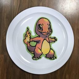 An image of a pancake drawn in the shape of Charmander from the Pokemon franchise.
