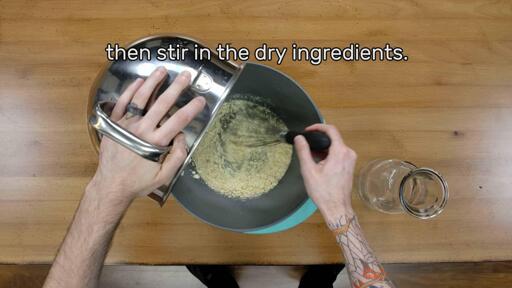 This image shows the dry powder being stirred into the water in a mixing bowl with a whisk, and says