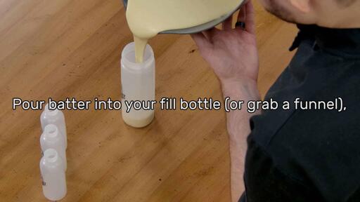 This image shows the batter being poured into the Dancakes Fill Bottle from the mixing bowl, and says