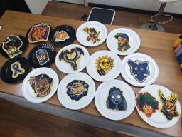 A collected shot of all of the different pieces of pancake art that were made during the September 13 2020 request livestream. All of the pancakes in this gallery are present, placed across the rich wood color of the dancakes studio countertop. You can see the displaced griddle resting on the floor just in the background, and a few of the color bottles used to make these pancakes rest off to the right side of the photo.